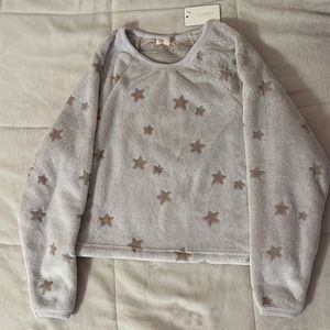 A gray sweater with a soft touch and light brown colored stars all over